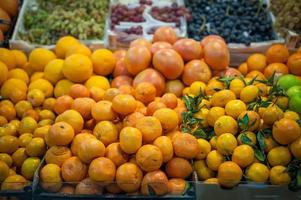 Fruit market with various colorful fresh fruits and vegetables photo