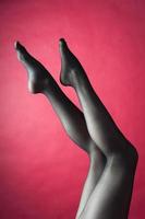 Legs of young caucasian woman in black tights photo