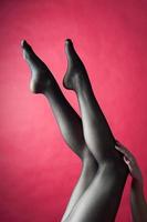 Legs of young caucasian woman in black tights photo