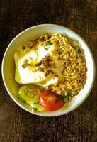 boiled noodle soup with eggs and complete toppings photo