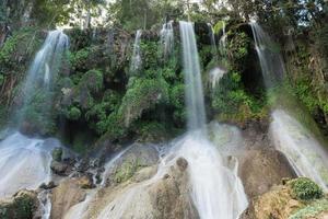 El Nicho Waterfalls in Cuba. El Nicho is located inside the Gran Parque Natural Topes de Collantes, a forested park that extends across the Sierra Escambray mountain range in central Cuba. photo