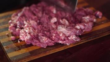 close up of man cut pieces of raw meat video