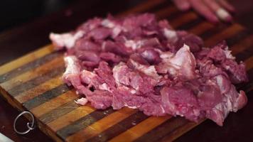 close up of man cut pieces of raw meat video