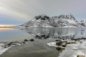 Vagspollen reflection at sunrise in the Lofoten Islands, Norway in the winter. photo