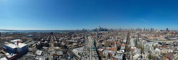 Brooklyn, New York - Apr 8, 2021 -  Panoramic view of the Gowanus Expressway in Brooklyn, New York with the Manhattan skyline in the background. photo