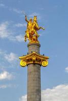 Tbilisi, Georgia - July 12, 2018 -  Golden statue of St. George on the main square of Tbilisi, capital city of Georgia. photo