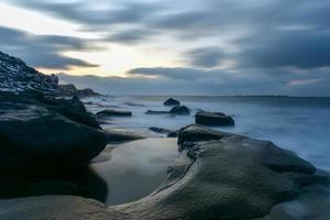 Waves flowing over Utakleiv Beach, Lofoten Islands, Norway in the winter. photo