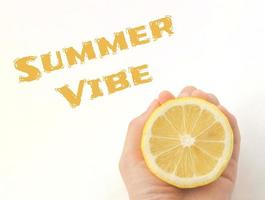 Hand holds a lemon. Half lemon. Lemon slice. Text summer vibe. photo