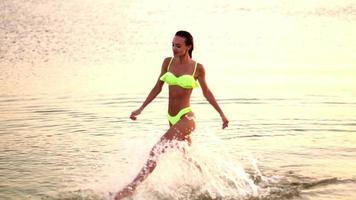 young lady in swimsuit at sunset at the warm evening video