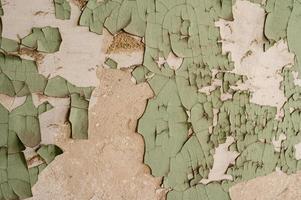 peeling paint on the wall of an old and abandoned house. photo