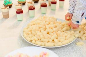 birthday of a child, sweet candy bar with corn sticks. photo