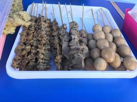 Selective focus Skewered food dish of chicken intestine, quail eggs, and  various satays, from intestinal satay to egg satay and liver satay. photo