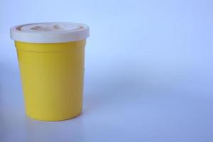 small yellow bottle on a plain white background photo