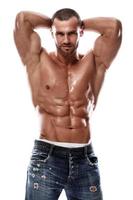 Handsome muscular man wearing jeans posing in studio photo