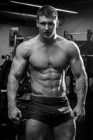 Muscular man in gym photo