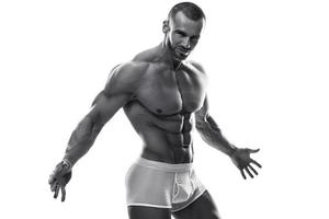 Handsome man posing wearing underwear on white background photo