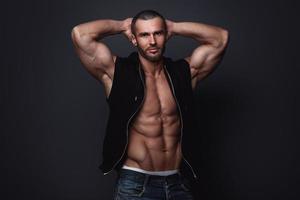 Portrait of handsome muscular man posing in studio photo