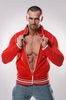 Handsome and muscular man in red jacket photo