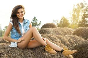 Happy woman and haystacks in the village photo