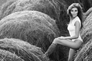 Sexy woman in white bodysuit among the haystacks photo