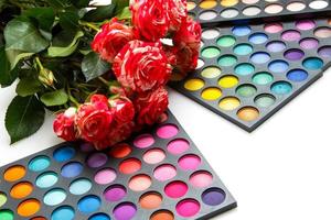 Rose flowers and palettes with eyeshadows photo