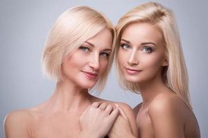 Portrait of beautiful mother and daughter in studio photo