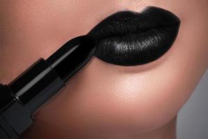 Closeup of black female lips and lipstick photo