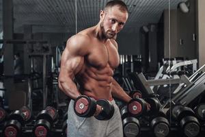 Muscular man doing a exercise for biceps photo