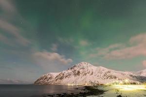 Northern lights over the sea at Vareid, Lofoten Islands, Norway in the winter. photo