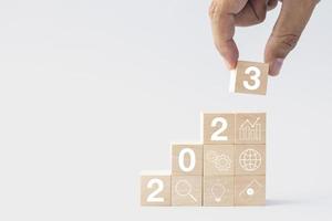 2023 business growing growth concept to success. hand picking woods block step with icon concept about business strategy, Action plan, Goal and target, hand stack, project, vision. photo