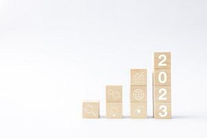 2023 business growing growth concept to success. woods block step with icon concept about business strategy, Action plan, Goal and target, hand stack, project, vision. photo