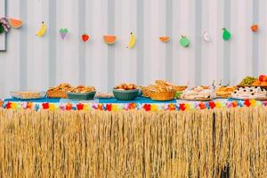 Side view of assortment of finger party food on a table with decorations photo