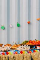 Side view of assortment of finger party food on a table with decorations photo