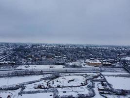 High angle view of Snow covered North Luton's landscape and Cityscape, Aerial Footage of Northern Luton City of England UK after Snow Fall. The 1st Snow Fall of this Winter of 2022 photo