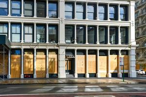 New York City, New York - June 11, 2020 -  Store closed during the COVID-19 pandemic, with boarded up windows to protect against looting as a result of anti-police brutality protests. photo