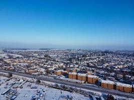 High angle view of Snow covered North Luton's landscape and Cityscape, Aerial Footage of Northern Luton City of England UK after Snow Fall. The 1st Snow Fall of this Winter of 2022 photo