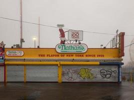 Brooklyn, New York - February 11, 2018 -  Nathan's Famous Hot Dogs in Coney Island, Brooklyn on a foggy day. photo