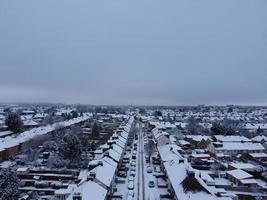 High angle view of Snow covered North Luton's landscape and Cityscape, Aerial Footage of Northern Luton City of England UK after Snow Fall. The 1st Snow Fall of this Winter of 2022 photo