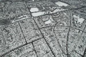 High angle view of Snow covered North Luton's landscape and Cityscape, Aerial Footage of Northern Luton City of England UK after Snow Fall. The 1st Snow Fall of this Winter of 2022 photo