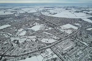 High angle view of Snow covered North Luton's landscape and Cityscape, Aerial Footage of Northern Luton City of England UK after Snow Fall. The 1st Snow Fall of this Winter of 2022 photo