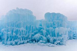 Translucent blue icicles in a frozen ice wall. photo