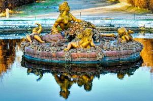 Versailles, France - November 26, 2006 -  Fountain in the Gardens of Versailles Palace in Versailles. The Palace of Versailles is a royal chateau with beautiful gardens and fountains. photo