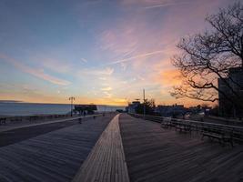 Dramatic Sunset along the boardwalk of Coney Island in Brooklyn, New York photo