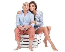 Woman and her eldery father on white background photo