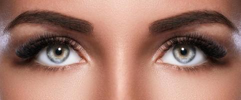 Female face with beautiful eyebrows and artificial eyelashes photo