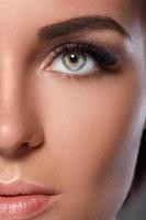 Female face with beautiful eyebrows and artificial eyelashes photo