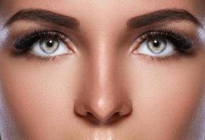 Female face with beautiful eyebrows and artificial eyelashes photo