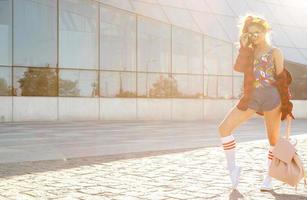 Stylish teenage girl with backpack on the street photo