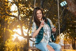 Beautiful woman taking selfie in autumn park photo