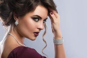 Young gorgeous woman which wearing beautiful jewellery photo